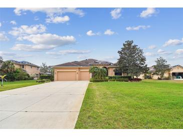 Charming single-story home with lush landscaping and a three-car garage at 1911 24Th Street W Cir, Palmetto, FL 34221