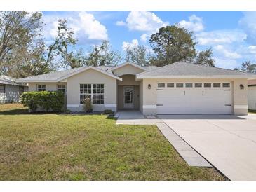 A charming single-Gathering home featuring a two-car garage, well-maintained lawn, and mature landscaping at 4117 Malden Dr, Sarasota, FL 34241