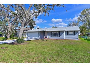 Charming single-story home featuring a well-manicured lawn and a classic architectural style at 5606 79Th E Ave, Palmetto, FL 34221