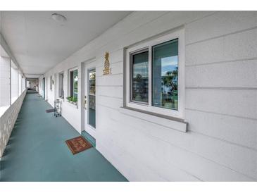 Inviting condo featuring a cozy entryway with a decorative pineapple and a well-lit corridor at 5892 17Th W St # C25, Bradenton, FL 34207