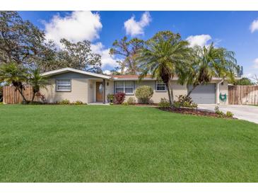 Beautiful single-story home featuring a well-manicured front lawn and mature palm trees, perfect for curb appeal at 3053 Concord St, Sarasota, FL 34231