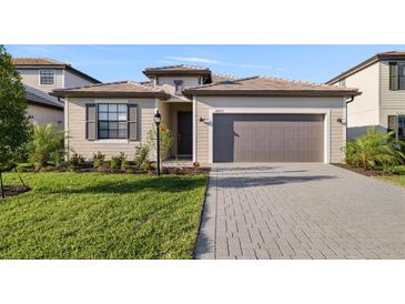 Charming single-story home boasts a well-manicured lawn, lovely landscaping, and a two-car garage at 3603 Night Star Terrace, Parrish, FL 34219