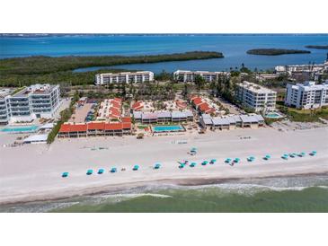 Breathtaking aerial view of oceanfront condos with a pristine beach and clear blue waters at 4621 Gulf Of Mexico Dr # 19B, Longboat Key, FL 34228