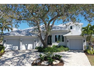Stunning single-story home with a three-car garage and meticulously maintained landscaping at 5169 Sandy Shore Ave, Sarasota, FL 34242