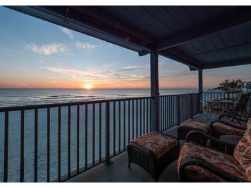 Relaxing balcony view with comfortable seating and a stunning ocean sunset at 6700 Gulf Dr # B8, Holmes Beach, FL 34217