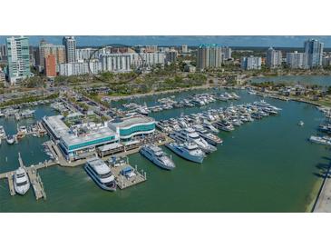 Aerial shot of a waterfront with docked yachts and buildings, creating a vibrant city and harbor scene at 101 S Gulfstream Ave # 4J, Sarasota, FL 34236