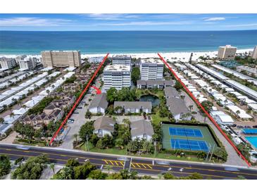 Beautiful beachfront community featuring lush landscaping, tennis courts, and a pristine view of the ocean at 1141 W Peppertree Dr # 1141, Sarasota, FL 34242