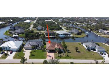 Beautiful waterfront property featuring lush landscaping and private boat dock at 15484 Alsask Cir, Port Charlotte, FL 33981