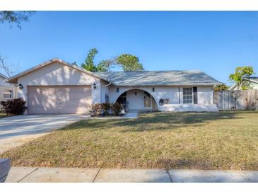 Charming single-story home featuring an attached garage, arched entryway, and well-maintained front lawn at 4102 29Th W Ave, Bradenton, FL 34205