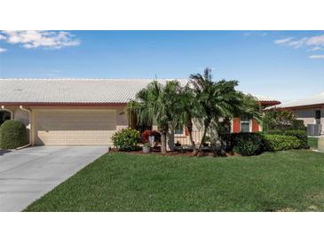 Charming home with a well-manicured lawn, mature landscaping, and an attached two-car garage at 6608 13Th Avenue W Dr, Bradenton, FL 34209