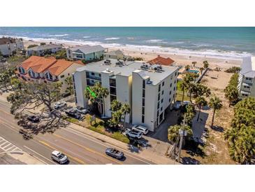Beachfront condo building featuring a coastal design and beautiful ocean views at 1300 Gulf Blvd # 202, Indian Rocks Beach, FL 33785