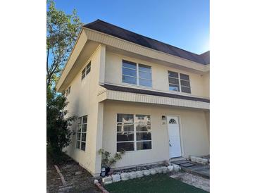 Charming two-story townhouse with neutral stucco, multi-pane windows and well-lit entry at 216 Amherst Ave # 97, Sarasota, FL 34232
