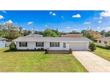 Charming single-story home with a well-manicured lawn and an attached one-car garage at 6349 5Th Street E Cir, Bradenton, FL 34203