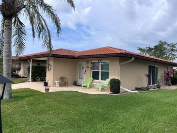 Charming home featuring a terracotta tile roof, manicured lawn, and cozy outdoor seating area at 3113 Cambridge Ave # 3113, Bradenton, FL 34207