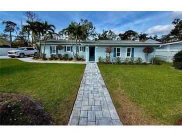 Charming single-story home with a landscaped front yard, stone walkway, and inviting curb appeal at 4218 S Lockwood Ridge Rd, Sarasota, FL 34231