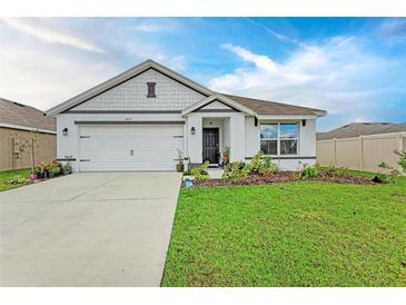 Charming single-story home featuring a manicured lawn and a two-car garage at 4411 Hearthstone Run, Palmetto, FL 34221