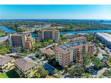 Breathtaking aerial view showcases the complex's waterfront location with stunning views of the river at 5591 Cannes Cir # 403, Sarasota, FL 34231