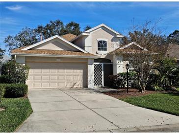 Charming two-story home with a well-manicured lawn, complemented by a two-car garage and traditional design at 1155 Millbrook Cir, Bradenton, FL 34212