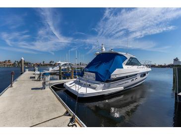 View of a covered boat at the dock with clear blue sky at 1318 3Rd Street E Cir, Palmetto, FL 34221