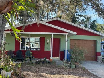Charming, single-story home with green and red exterior and a well-maintained front yard at 1782 Mississippi Ne Ave, St Petersburg, FL 33703