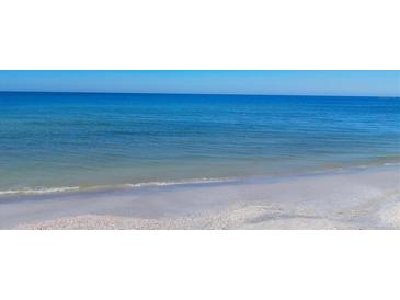 A scenic view of the beach with crystal blue water and white sand at 2100 Benjamin Franklin Dr # 204, Sarasota, FL 34236