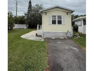 Charming yellow home with a well-maintained lawn and paved driveway at 3333 26Th E Ave # 1025, Bradenton, FL 34208