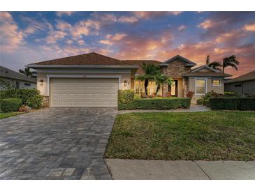Beautiful single-story home features a well-manicured lawn, stone accents, and a spacious two-car garage at 368 Snapdragon Loop, Bradenton, FL 34212