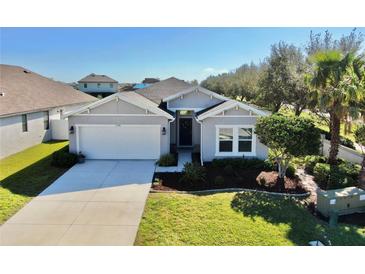 Charming single-story home with a well-manicured lawn and an attached two-car garage at 3708 Wayfarer Way, Palmetto, FL 34221