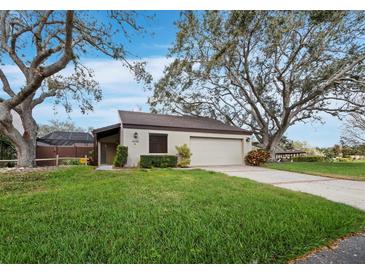 Charming one-story home with a well-manicured lawn and mature oak trees providing ample shade at 3729 Glen Oaks Manor Dr, Sarasota, FL 34232