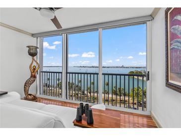 Bright living room showcasing floor-to-ceiling windows with beautiful water views and a mermaid statue at 435 S Gulfstream Ave # 1103, Sarasota, FL 34236