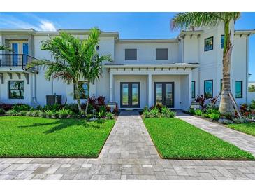 Charming townhome with well-manicured lawn, professional landscaping and a beautiful stone walkway at 6013 White Mangrove Ln, Bradenton, FL 34210