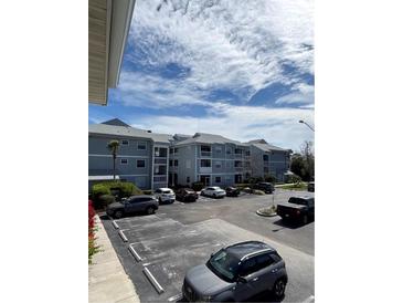 View of the condo building featuring ample parking and balconies at 6924 Stones Throw N Cir # 8105, St Petersburg, FL 33710