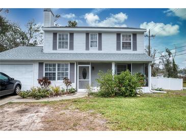 Charming two-story home featuring a well-maintained lawn and inviting front porch at 7067 Jarvis Rd, Sarasota, FL 34241