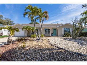 Charming home with a well-maintained front yard with gravel and tropical landscaping, including mature palm trees at 919 68Th Nw St, Bradenton, FL 34209