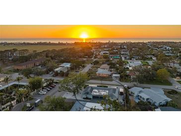 Stunning aerial view of home near beach, highlighting its prime location and neighborhood charm at sunset at 101 Base E Ave # 101 103, Venice, FL 34285