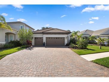 Beautiful home exterior with a paved driveway, a three car garage and manicured landscaping at 11981 Hunters Creek Rd, Venice, FL 34293