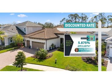 Charming two-story home featuring a well-manicured lawn and a sign promoting a discounted interest rate at 11981 Hunters Creek Rd, Venice, FL 34293