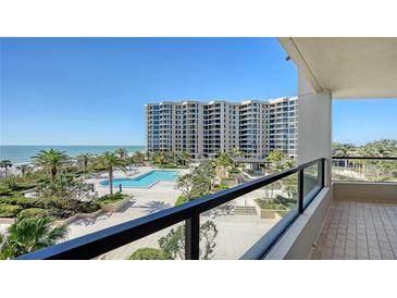 View from the balcony overlooking the beautiful pool, manicured gardens and sparkling ocean at 1211 Gulf Of Mexico Dr # 207, Longboat Key, FL 34228