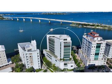 Aerial shot of the property highlighting its prime waterfront location and modern architectural design at 280 Golden Gate Pt # 400, Sarasota, FL 34236