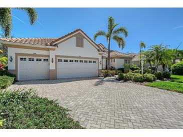 Charming home featuring a spacious three-car garage and meticulously manicured landscaping at 8215 Waterview Blvd, Lakewood Ranch, FL 34202