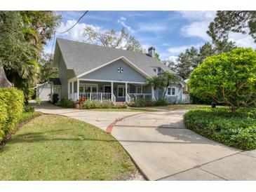 Charming two-story home with a welcoming front porch and beautifully landscaped front yard at 1231 S Orange Ave, Sarasota, FL 34239