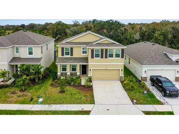 Charming two-story home with a manicured lawn and a paved driveway, offering inviting curb appeal at 12534 Nantahala Run, Parrish, FL 34219
