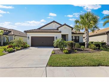 Charming home with manicured lawn and mature landscaping creates inviting curb appeal at 220 Cassano Dr, Nokomis, FL 34275