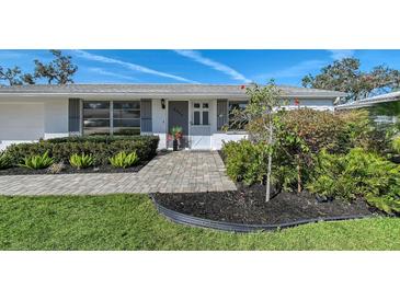 Charming single-story home featuring well-manicured landscaping and a welcoming front entrance at 2406 Breakwater Cir, Sarasota, FL 34231