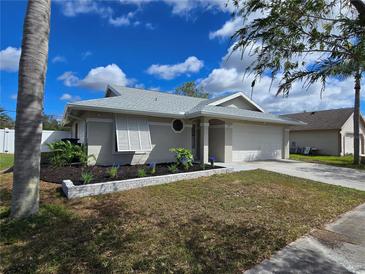 Beautifully landscaped single-story home with a two-car garage and shuttered windows at 3507 65Th Avenue E Cir, Sarasota, FL 34243