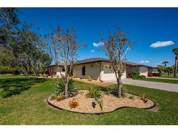 Well-maintained home featuring a manicured lawn, beautiful landscaping, and a two-car garage at 3641 Gleneagle Dr # 12D, Sarasota, FL 34238