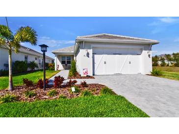 Charming single-Gathering home with a well-manicured lawn and two-car garage showcasing curb appeal at 8192 Sternway Rd, Sarasota, FL 34240