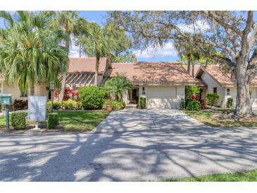 Charming villa with mature landscaping, tile roof and a two-car garage at 3214 Sandleheath # 64, Sarasota, FL 34235