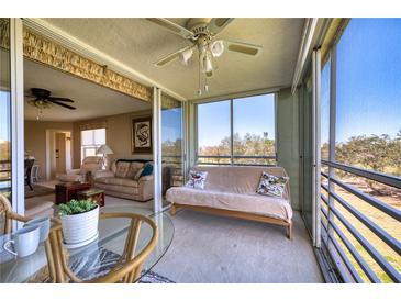 View from the lanai into the open and airy living room with comfortable seating at 4440 Fairways Blvd # 407, Bradenton, FL 34209