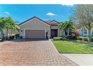 Charming single-story home boasts a paver driveway, well-manicured landscaping, and a tile roof at 4632 Benito Ct, Bradenton, FL 34211